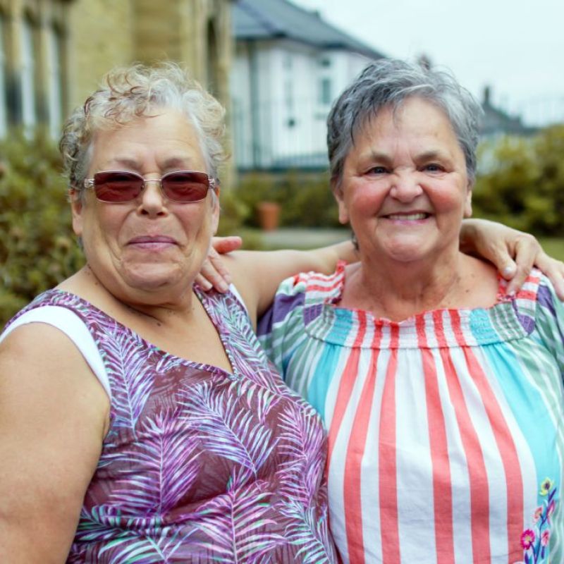 two females standing outside smiling
